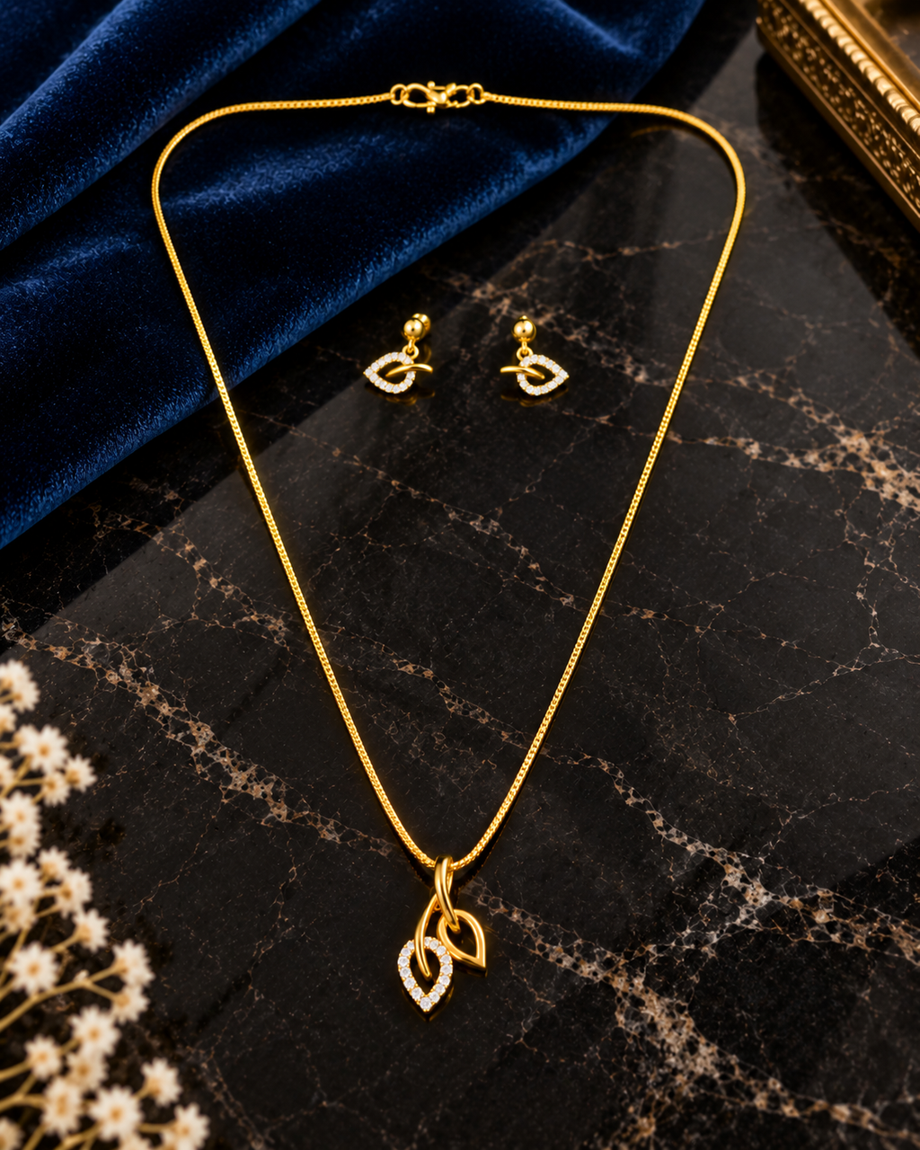 Dual leaf-shaped pendant with matching drop in a gold plated chain