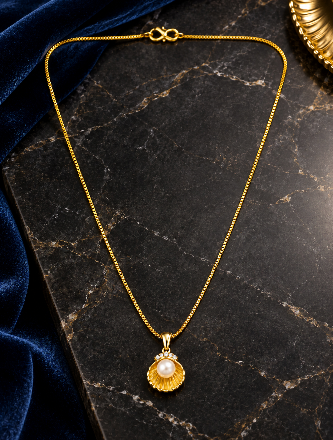 Shell inspired pearl pendant in a gold plated chain