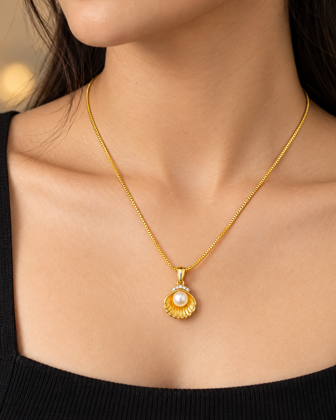 Shell inspired pearl pendant in a gold plated chain